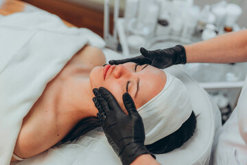 A girl at a cosmetologist does cosmetic procedures. Skin cleansing