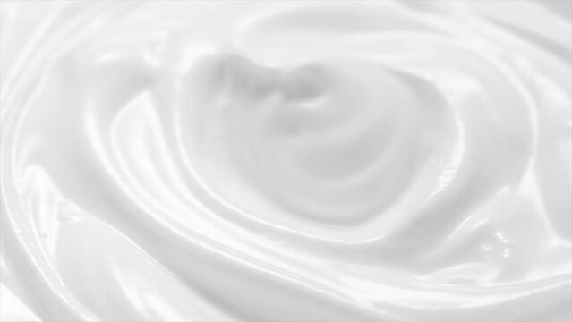 White cream swirl, rotating texture, White cream background, close up. Dairy product. Delicious organic creamy yogurt. Milk cream. 