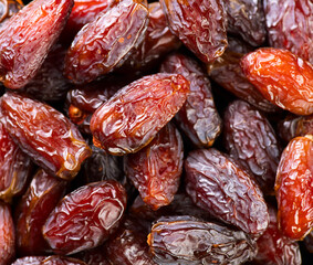 Date fruits. Dates fruit close up design background. Heap of Medjool dates close up, macro shot. Dried fruits, healthy vegan food backdrop. Top view