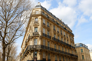 The facade of traditional French house with typical balconies and windows. Paris. - 760863303