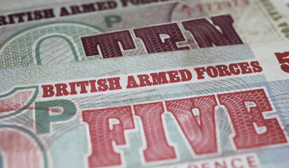 Obraz premium Closeup of old historical British Armed Forces banknotes (focus on center)