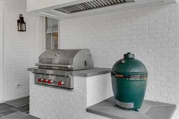 High-Quality Stainless Steel Outdoor Kitchen Setup with Grill, Pizza Oven, Vent Hood, Brick Wall,...