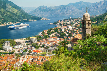 Fototapeta na wymiar Kotor bay with medieval church and old town from Lovcen Mountain, Montenegro. Adriatic fjord with boats and cruise ship in summer day. Travel destination