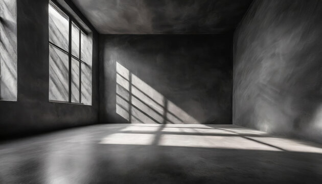 A room with a window and a black rough plaster wall, smooth concrete floor. The room is empty and the window is letting in sunlight
