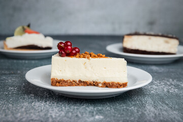 cheesecake with red currant on a grey background