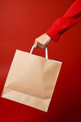 Shopping Elegance: Chic Beige Bag in Hand on Red Background