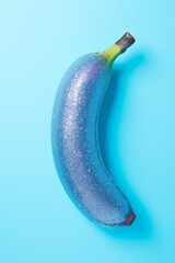 Glittery Banana: Sparkling Fruit on Blue Background for Creative Concept