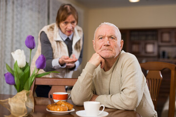 Annoyed elderly couple having conflict at home