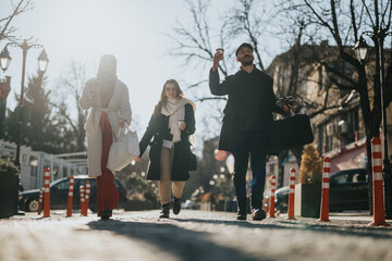 Three young adults enjoying a sunny urban outing, walking with shopping bags and coffee, embodying...