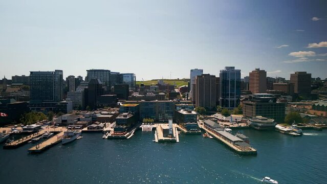 Aerial view of Halifax city with skyscrapers and piers with yachts and ships on a sunny day, Nova Scotia, Canada. Aerial view of coastal town and port town, resort town, landscape panorama