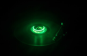 Music Dj concept. Trail of fire and smoke on vinyl record. Burning vinyl disk. Turntable vinyl record play Selective focus