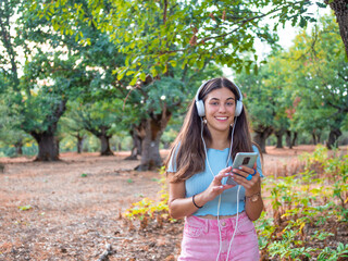 Pretty Girl Wearing Headphones and Listening to Music