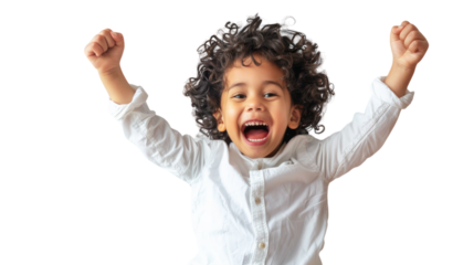 A little boy standing with his arms raised high in the air, expressing pure joy and freedom