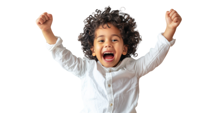 A little boy standing with his arms raised high in the air, expressing pure joy and freedom