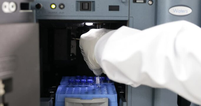 close up of science experiment Vials filling inside an autosampler of an HPLC machine inside view in a Scientific experimental laboratory for research development analysis and clinical trial study