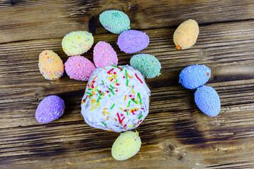 Traditional easter bread and easter eggs made of styrofoam on a wooden background. Top view