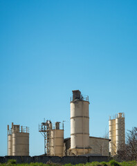 cement factory against cloudless sky