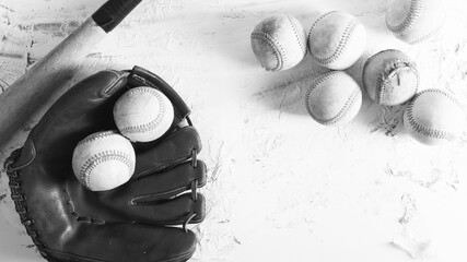 Old used baseball balls with bat and glove by copy space in black and white, sports equipment flat lay background scene. - 760915548