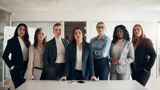 Diverse group of confident businesswoman standing together in an office in business suites