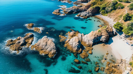 Aerial view of a paradise coast beach with sand, rocks and vegetation. Rocky shore with trees, turquoise blue calm water on sunny day. Summertime, documentary travel, holidays.