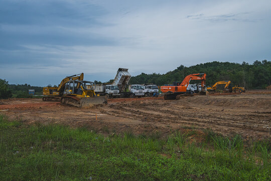 Balikpapan, Indonesia - March 10th, 2024. a group of heavy weight vehicles such as, bulldozers, tractors, and trucks on construction site.