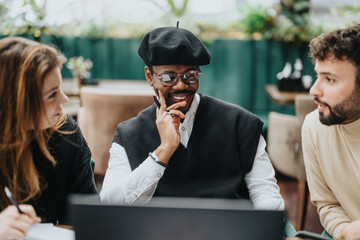 A multiethnic group of business colleagues collaborates over a laptop in a cozy restaurant environment, depicting teamwork and diversity.
