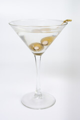 A martini glass filled with olive oil and olives