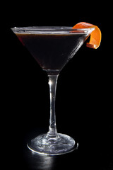 A martini glass with a slice of orange on top