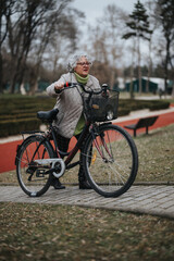Mature female retiree stays fit by cycling, embracing an active lifestyle outdoors.
