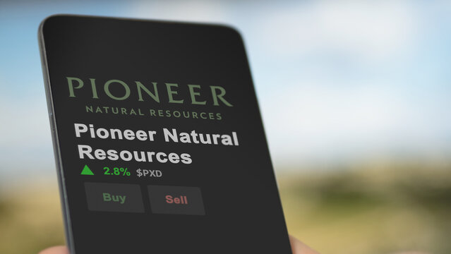 March 12th 2024 Irving, Texas. The logo of Pioneer Natural Resources on the screen of an exchange. Pioneer Natural Resources price stocks, $PXD on a device.