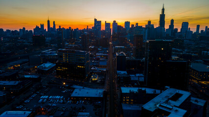 A captivating aerial view of a cityscape at dusk, showcasing illuminated skyscrapers against the...