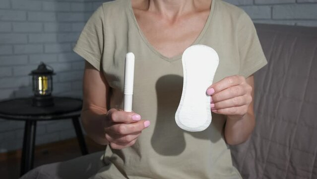 Hold personal hygiene items at home. A view of lady hands with personal hygiene items in the room.