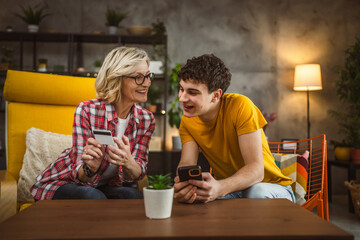 mother and son woman young man shopping online at home use credit card