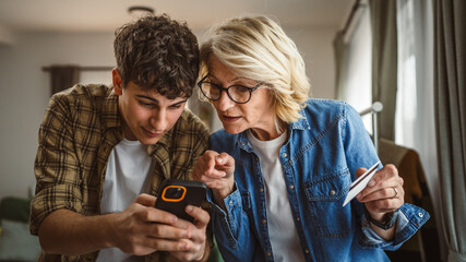 mother and son woman young man shopping online at home use credit card