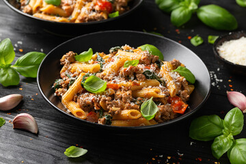 Creamy Tuscan pasta with minced beef, sun dried tomatoes, spinach and parmesan cheese