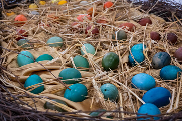 Easter painted eggs in a big nest straw background