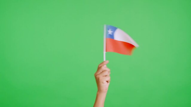 Hand waving a pennant of a chilean national flag