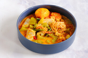lontong cap go meh, rice cake and vegetables coconut milk