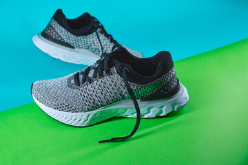 Top view shoes running on blue and green background. Concept healthy lifestyle outfit. Seasonal shoes for walking and sports