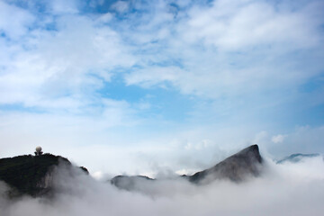 Fog begins to clear along the skyline of Tianmen Mountain