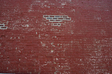 Red painted brick wall with exposed bricks