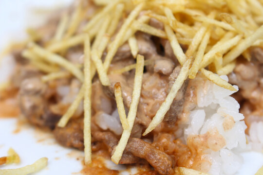 Brazilian stroganoff with straw potatoes. food with selective focus. meal details.