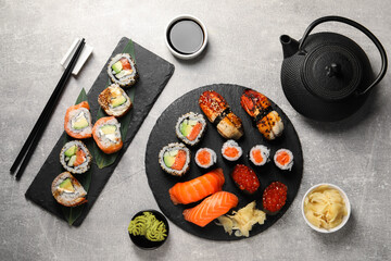 Flat lay composition with delicious sushi rolls on light grey table
