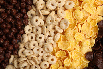 Different types of breakfast cereals as background, top view