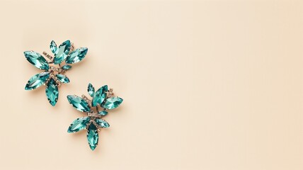 Elegant teal earrings on a plain background