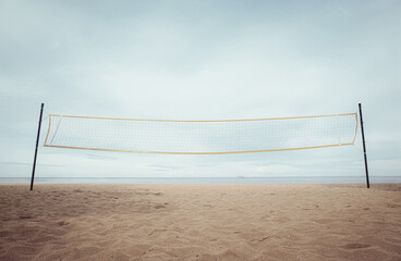 Beach volleyball net. Summer outdoor activities. Play sports on the sandy beach with seascape view.