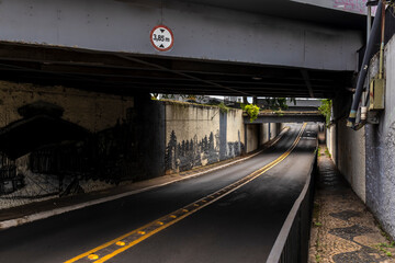 Marilia, Sao Paulo, Brazil, March 08, 2024. Street that passes under a viaduct, with a height limit...