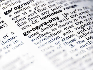 Closeup of the word geography in the dictionary
