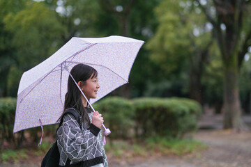 傘を差す小学生の女の子の横顔