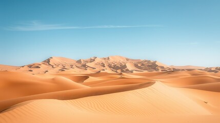 Fototapeta na wymiar A desert landscape with sand dunes and a clear blue sky